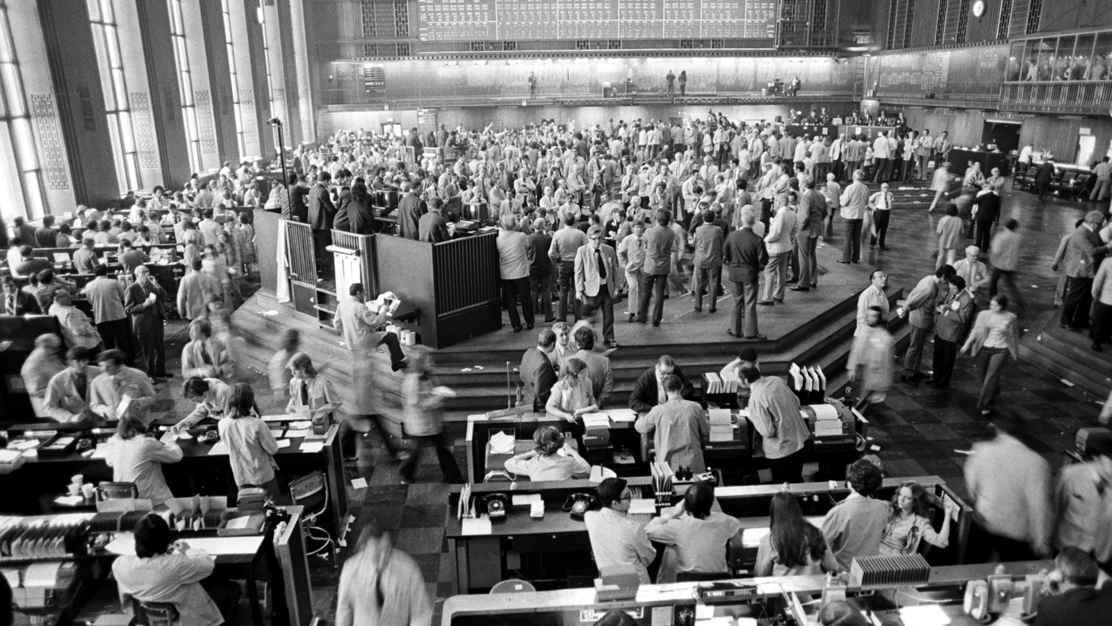 Archival black-and-white photograph of traders working on the Chicago Board of Trade floor in 1973.