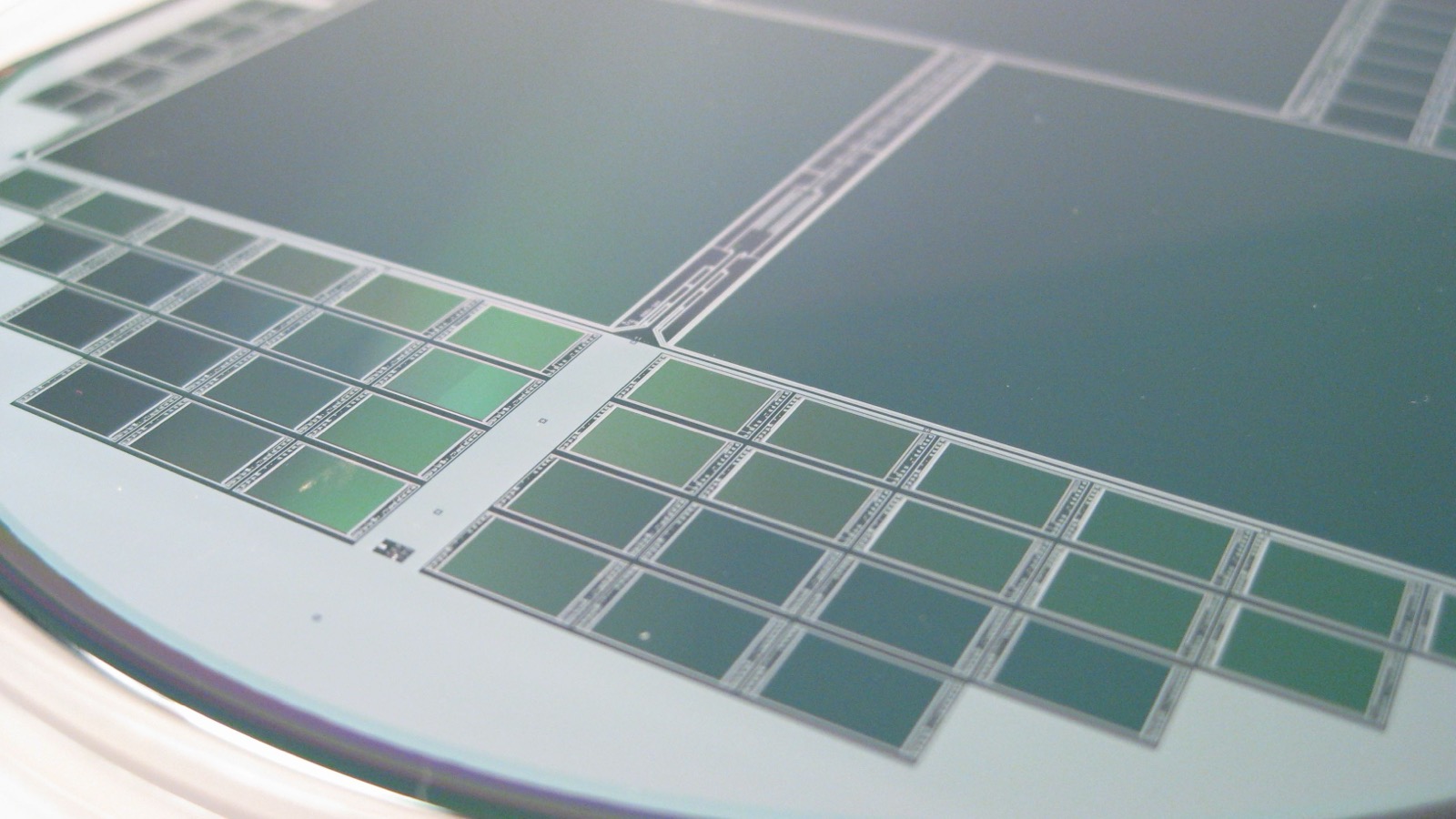 Close-up photograph of patterned dies on a semiconductor wafer.