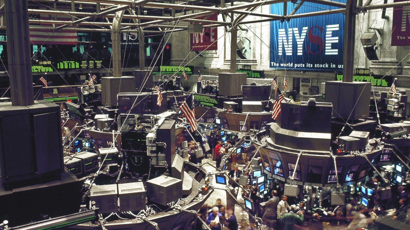 Traders work on the floor of the New York Stock Exchange in a documentary photograph