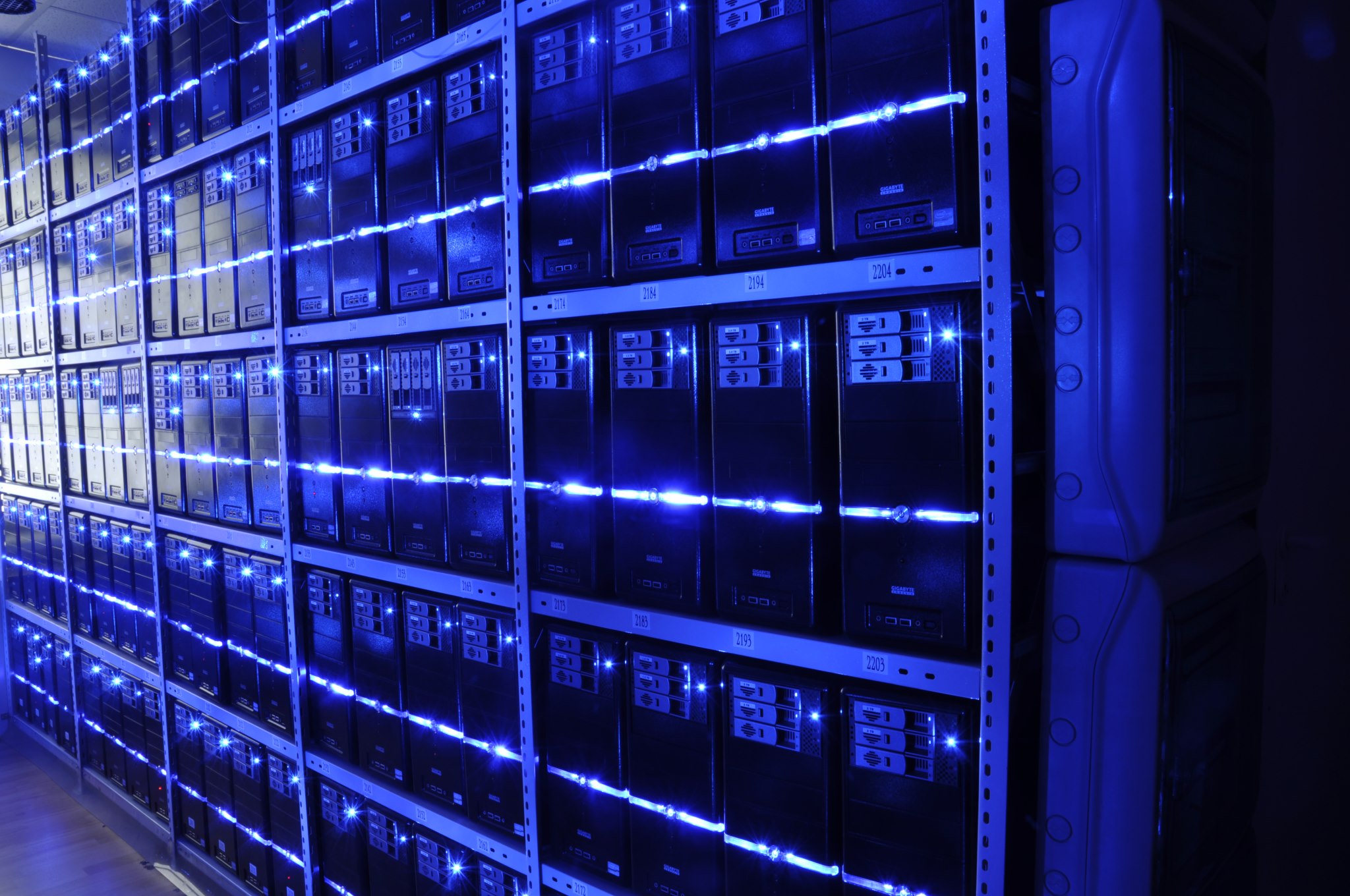Blue-lit server racks inside a data centre, illustrating the infrastructure used by data-intensive enterprise software