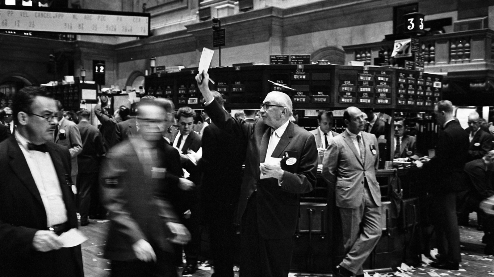 Stock brokers working on the New York Stock Exchange floor in 1963