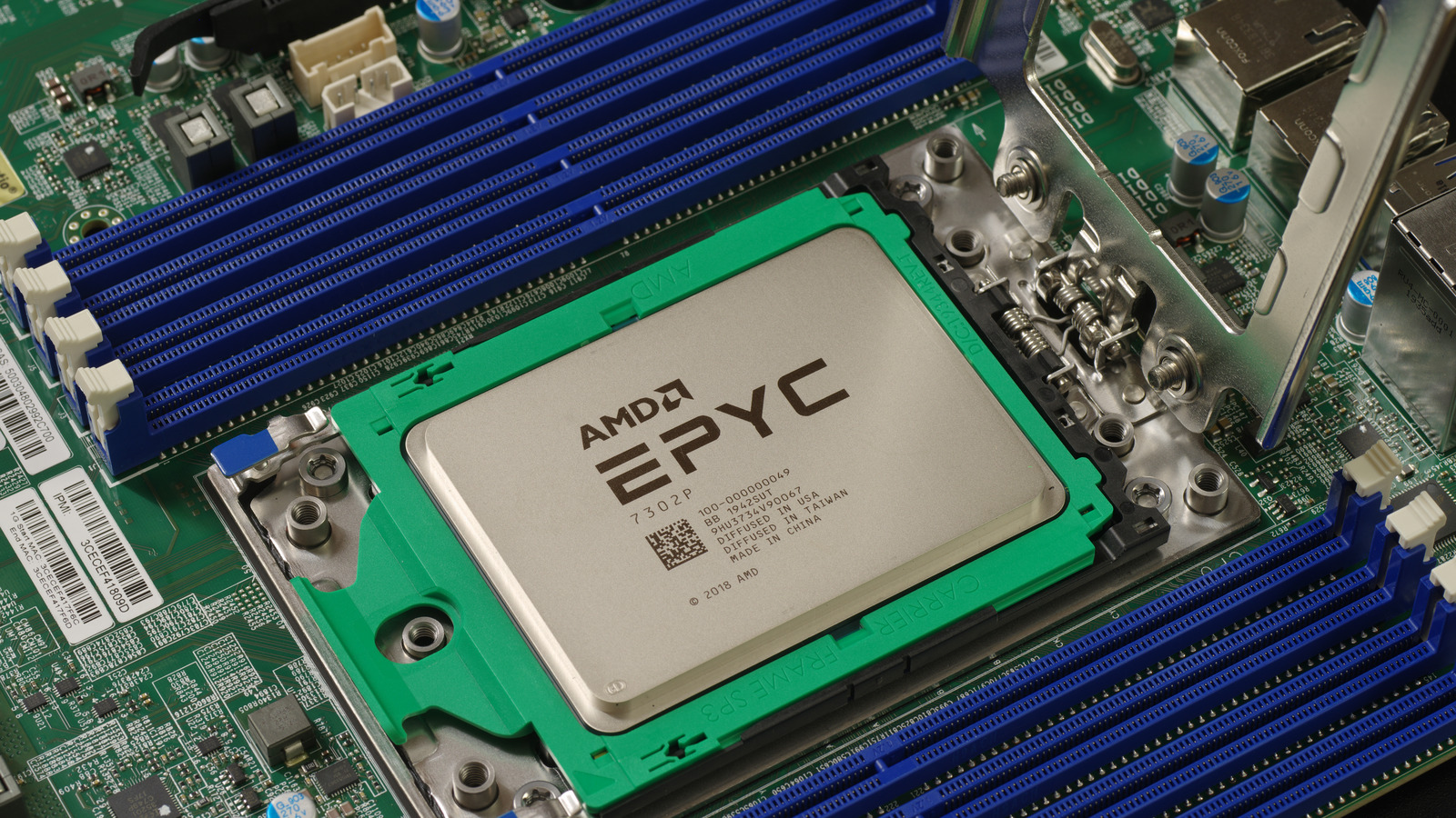 An AMD EPYC 7302P server processor seated in an open SP3 socket on a Supermicro motherboard.