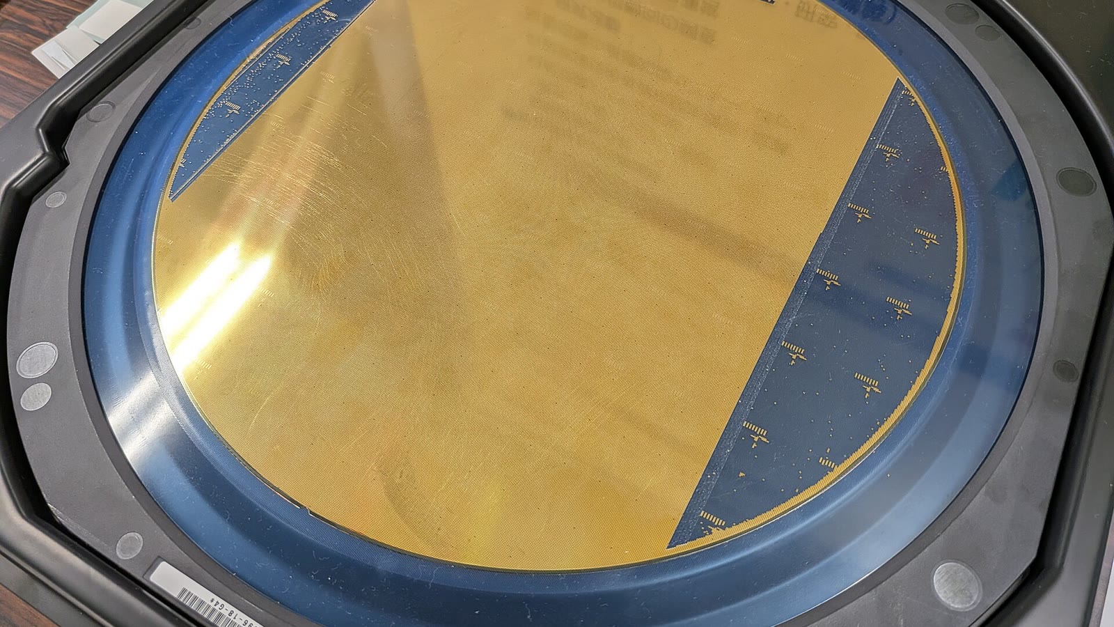Une plaquette dorée de micropuces semi-conductrices dans un support protecteur bleu
