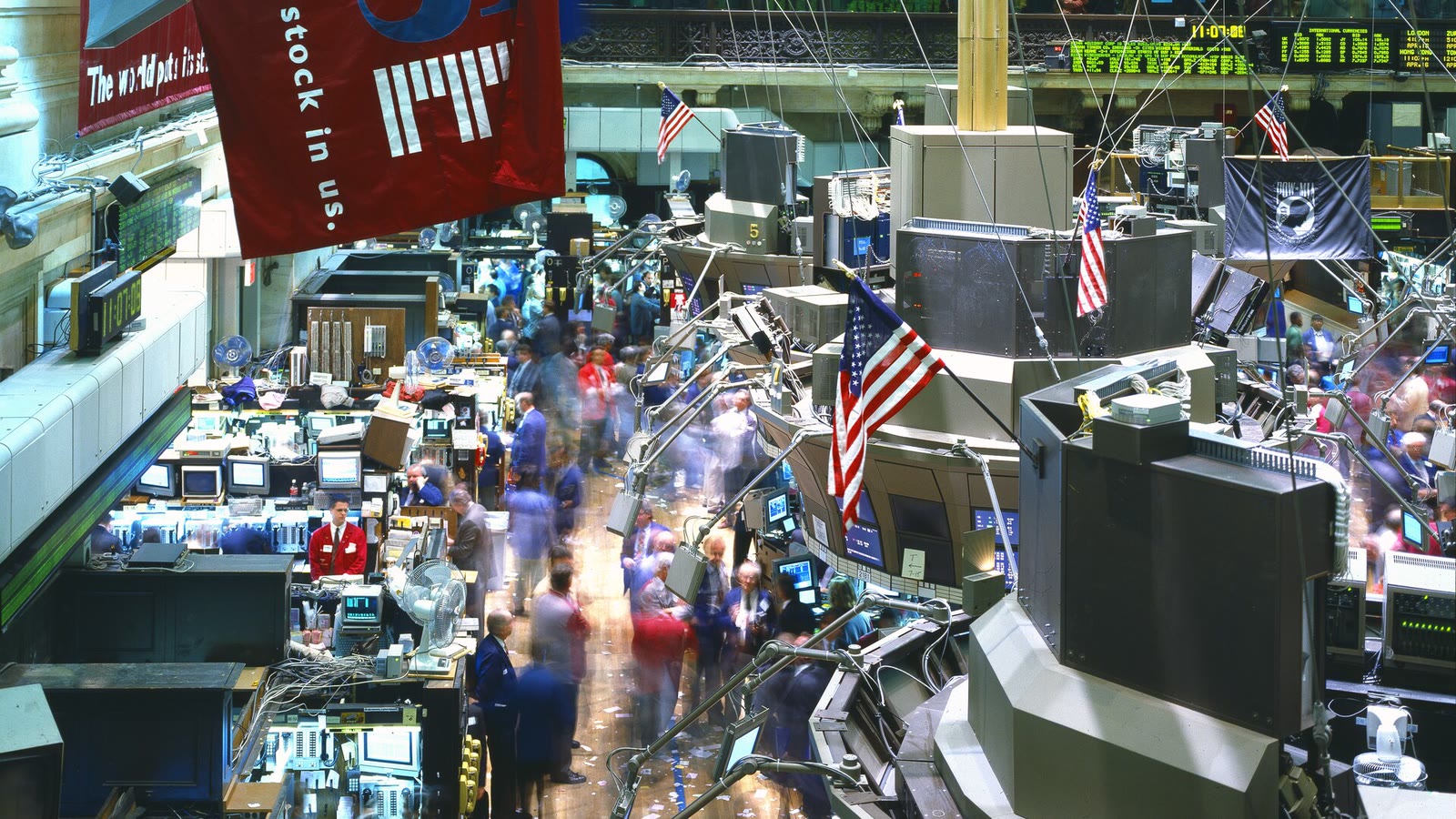 Traders working among screens and trading stations on the New York Stock Exchange floor