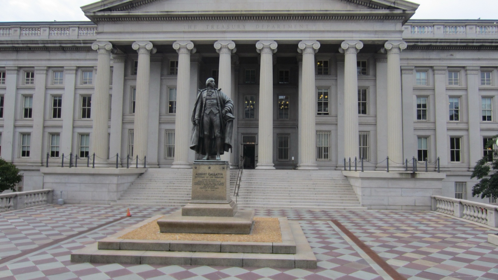 The U.S. Treasury Building’s columned façade behind the Albert Gallatin statue in Washington