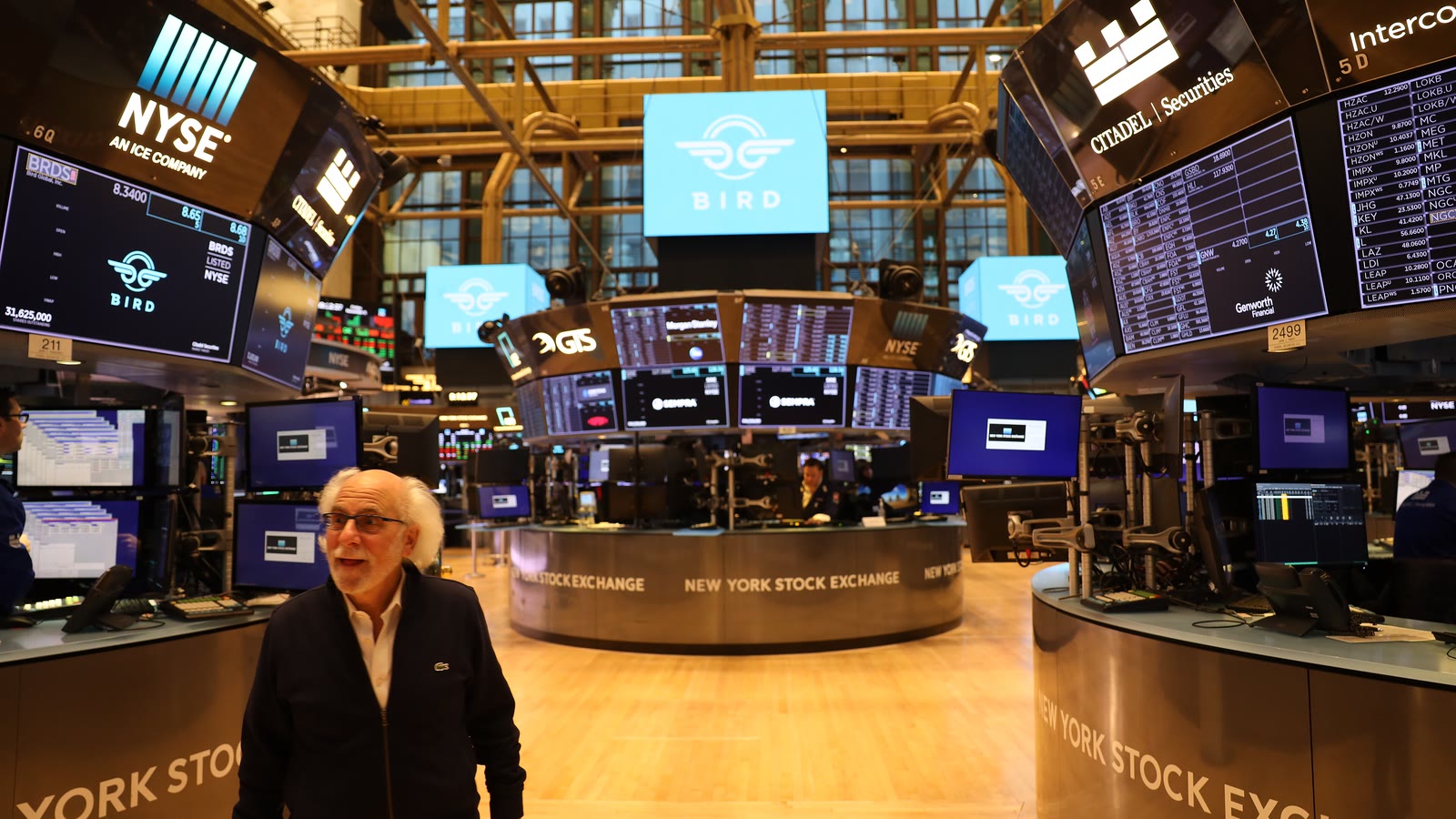 NYSE trader Peter Tuchman stands among trading desks and market screens on the exchange floor