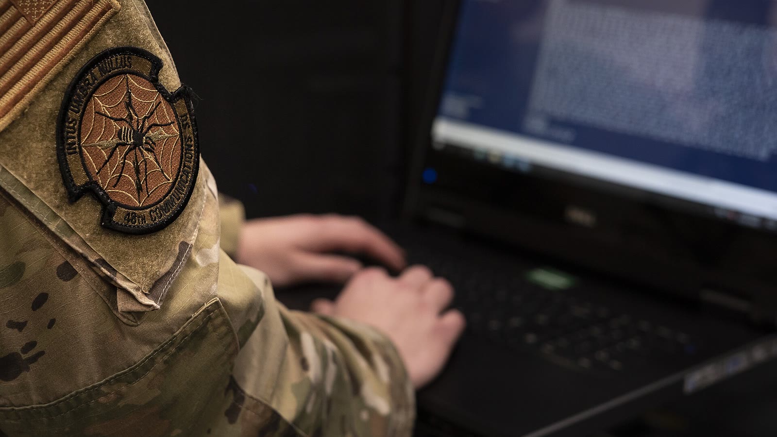 An Airman works on computer equipment inside a server room at RAF Lakenheath