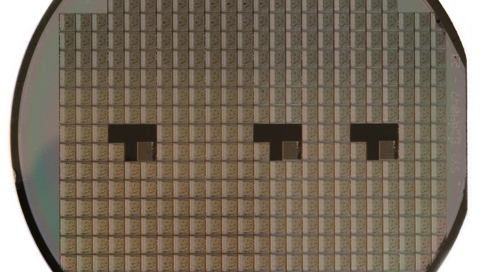 Close-up photograph of a patterned silicon semiconductor wafer