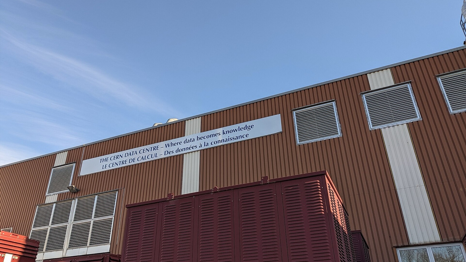 Exterior of a working data centre with cooling vents and infrastructure cabinets