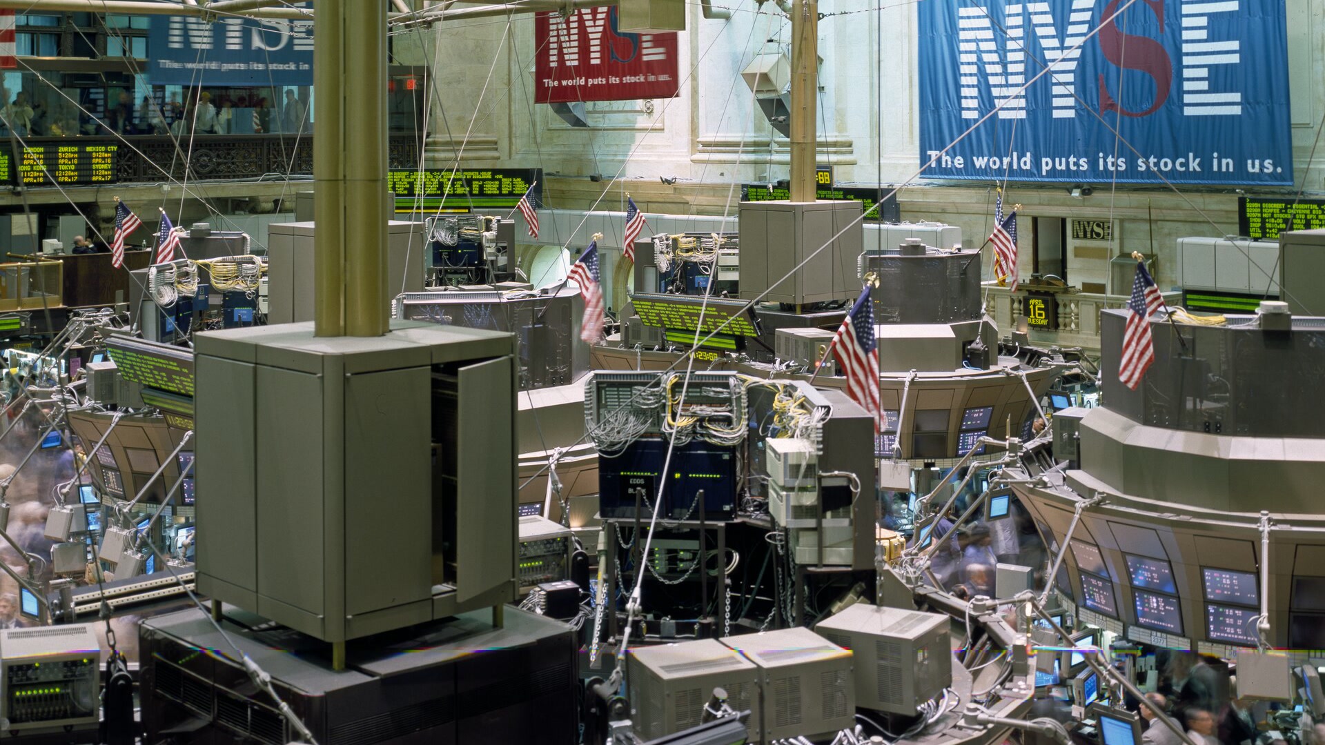 New York Stock Exchange trading floor with trading desks and market screens