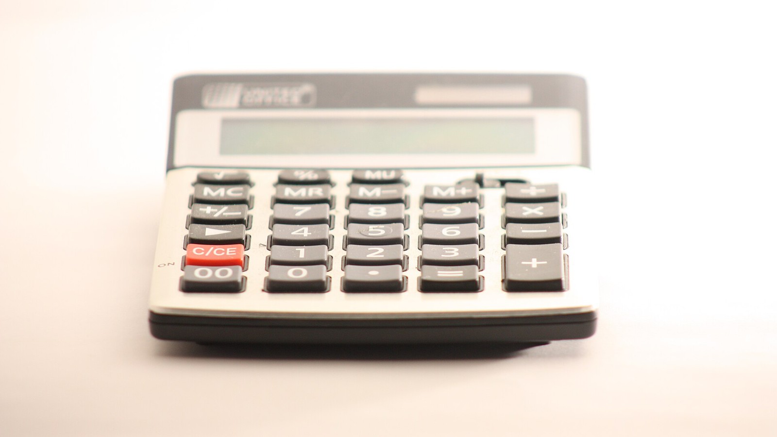 A desktop calculator on a light office surface