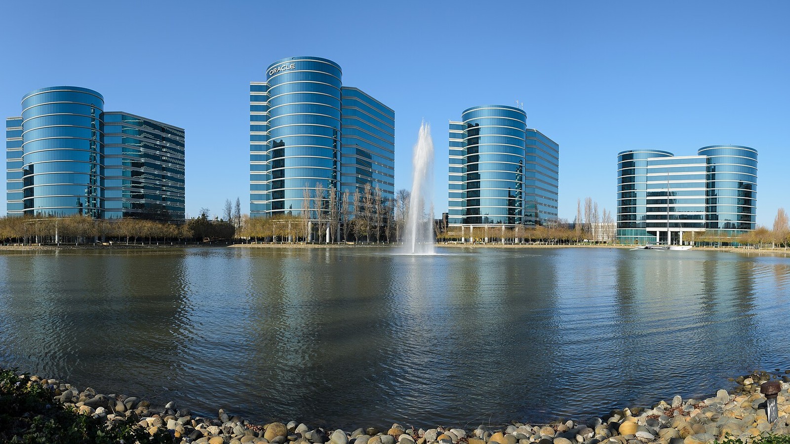 Oracle headquarters office towers and fountain across the Redwood Shores lagoon