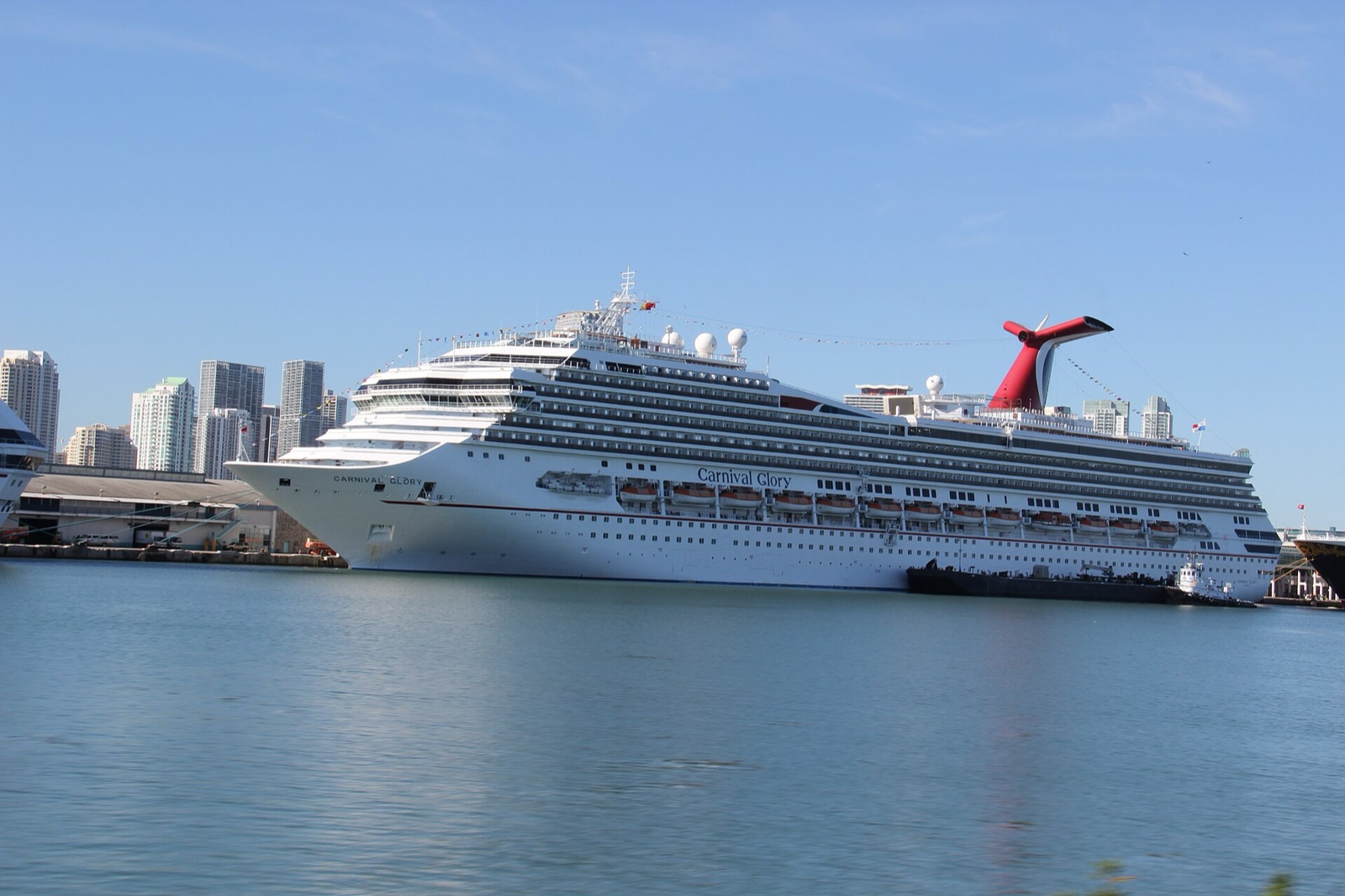 The Carnival Glory cruise ship docked at PortMiami with the Miami skyline behind it