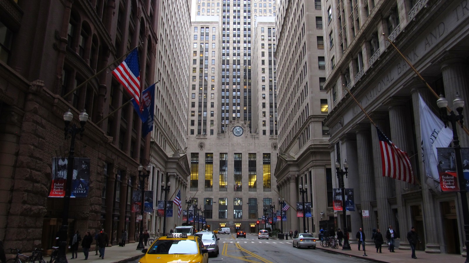 Archival view down LaSalle Street toward the Chicago Board of Trade building, with taxis and pedestrians.