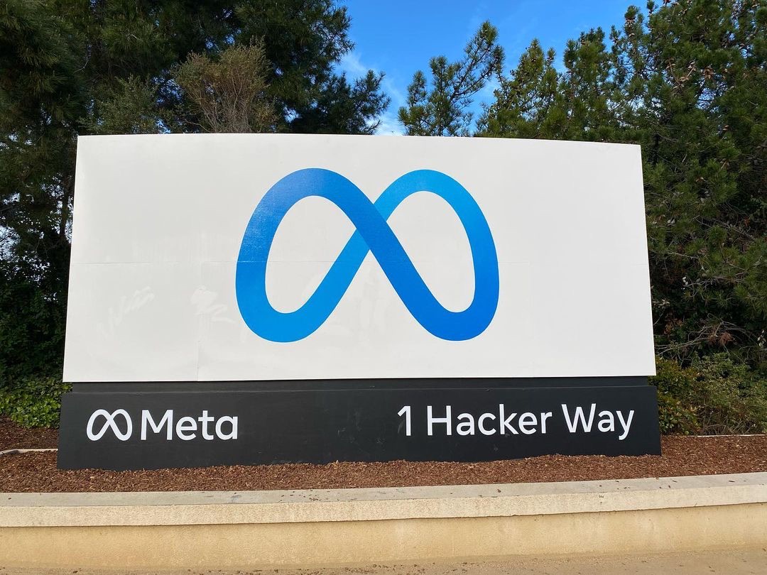 The Meta entrance sign with its blue infinity logo at the company's headquarters in Menlo Park, California