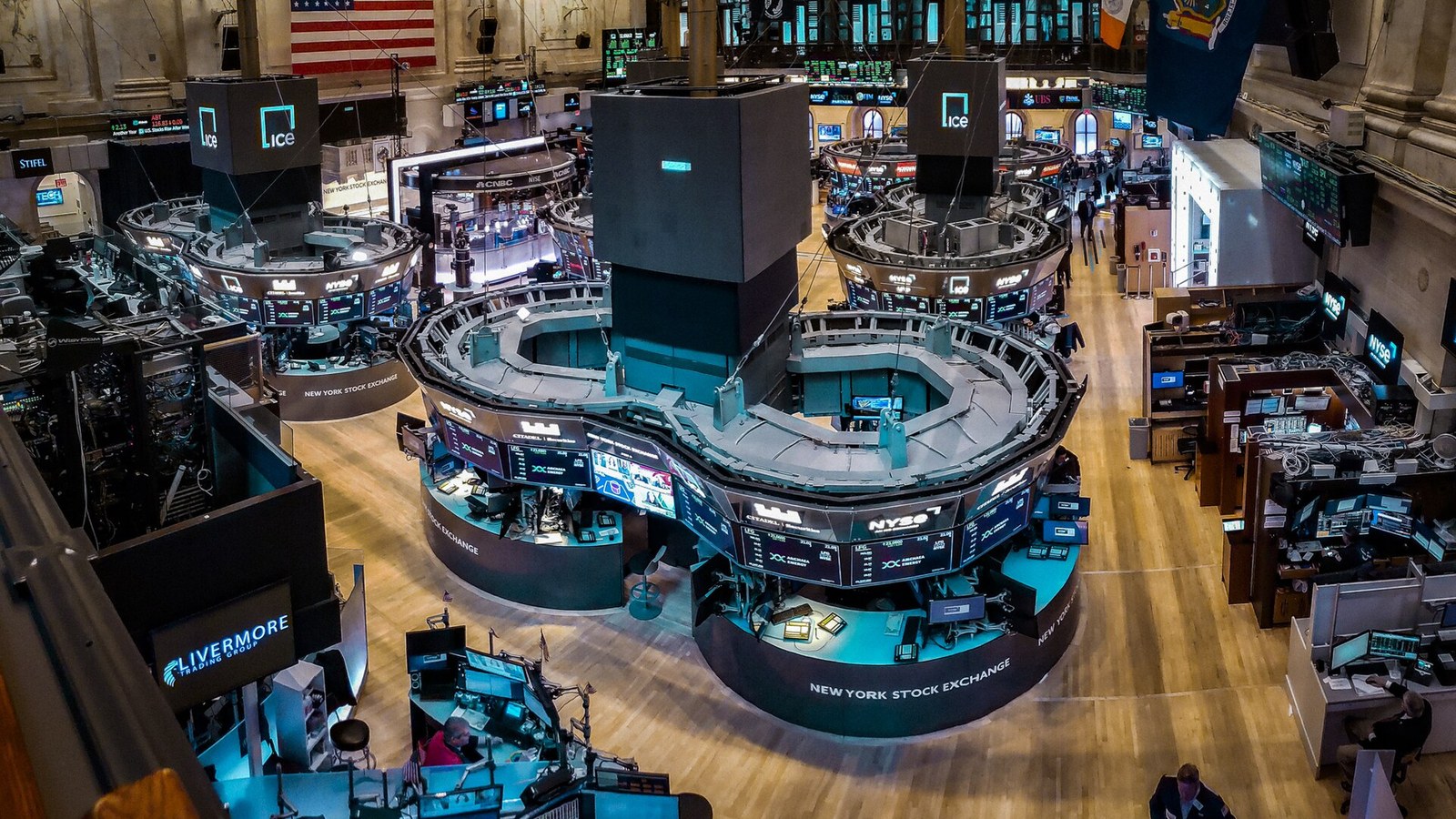 Trading desks and electronic quote screens on the New York Stock Exchange floor