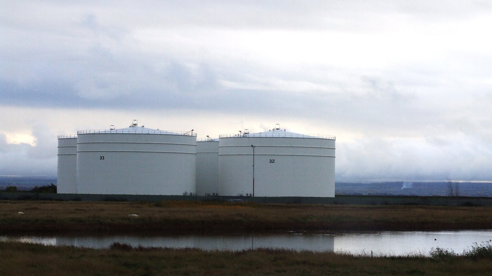 Oil storage tanks at the Isle of Grain refinery in England; industry context
