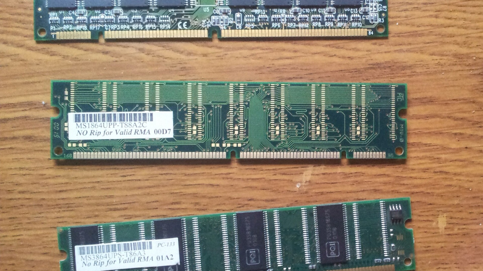Photograph of SDRAM memory modules on a wooden tabletop; illustrative hardware, not the ETF holdings