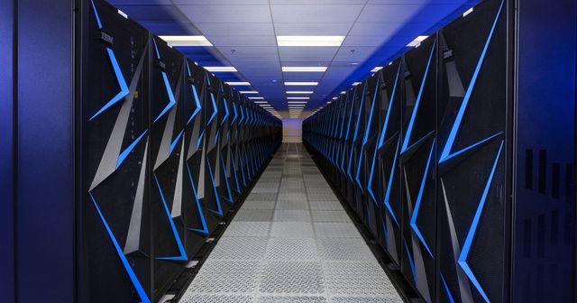 Rows of illuminated Sierra supercomputer cabinets inside Lawrence Livermore National Laboratory.