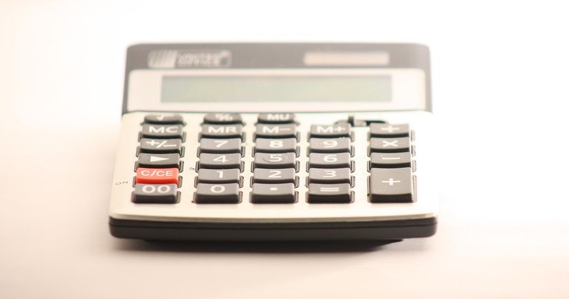 A desktop calculator on a light office surface