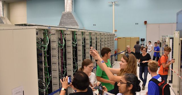 Visitors photograph server racks inside CERN’s computer centre