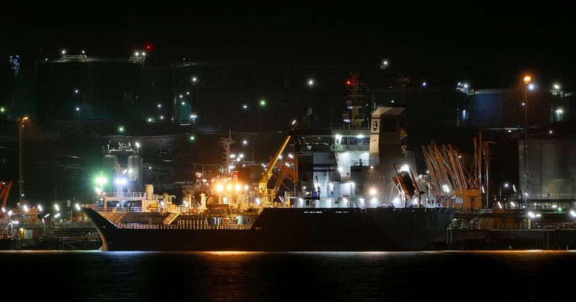 Tanker at the illuminated Preemraff Lysekil petroleum terminal in Sweden; archival oil-shipping photograph, not the Gulf