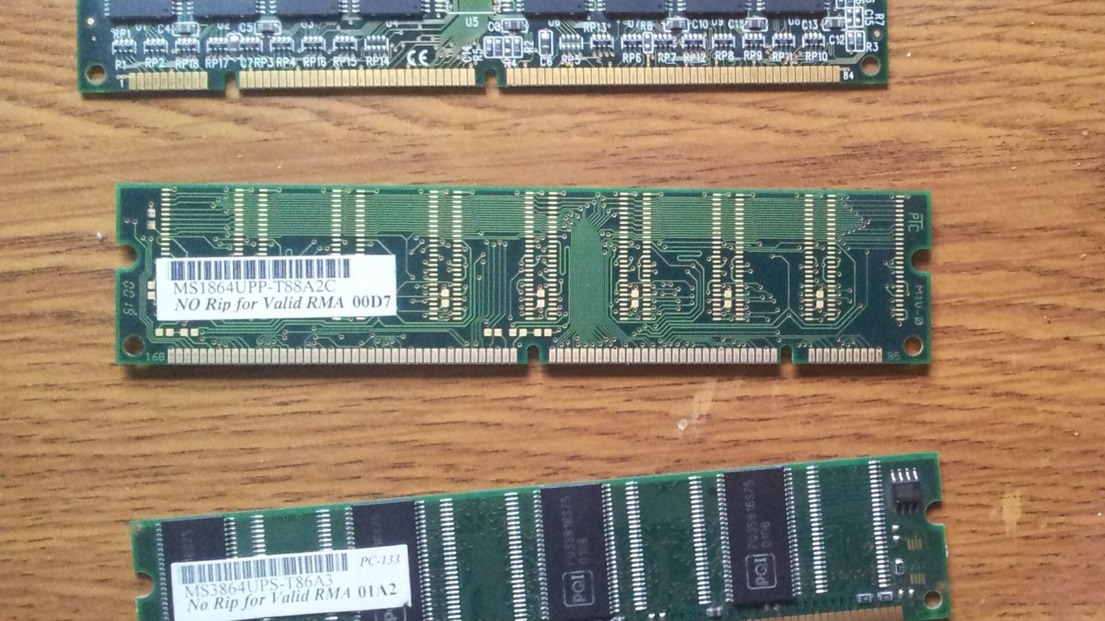 Photograph of SDRAM memory modules on a wooden tabletop; illustrative hardware, not the ETF holdings