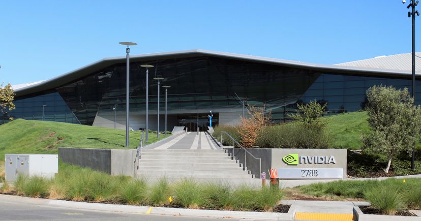 Archival August 2018 photograph of Nvidia's headquarters in Santa Clara, California, with a glass facade, landscaped slopes, stairs and a physical Nvidia sign.