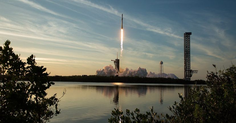 SpaceX Falcon 9 launches NASA's Crew-10 mission in March 2025, reflected across the water